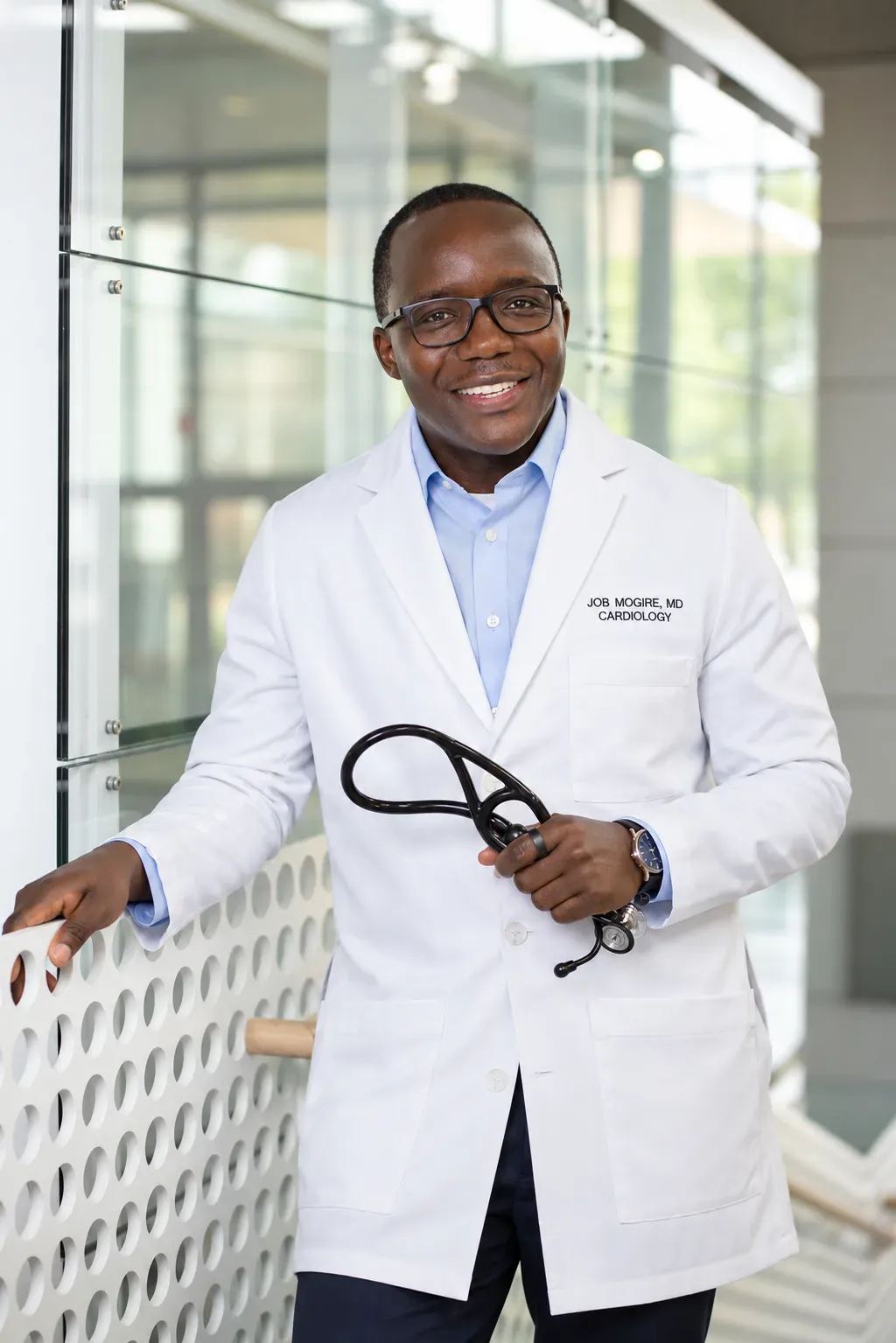 Dr. Job Mogire in his white cardiology coat, holding a stethoscope