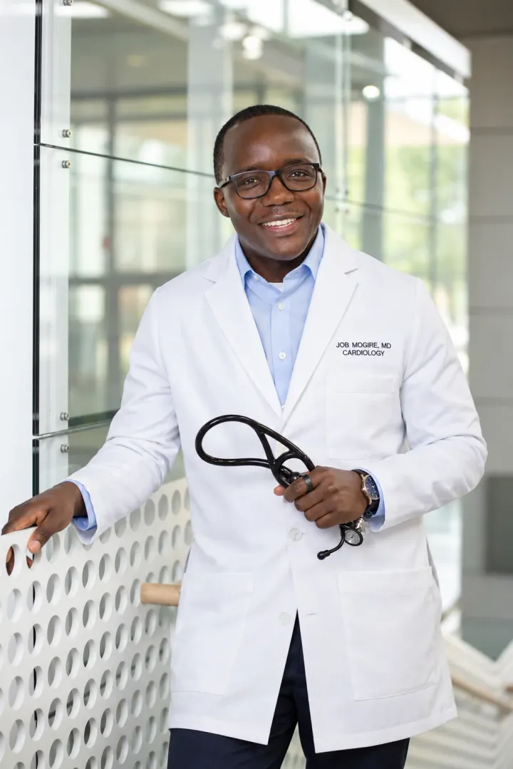 Dr. Job Mogire in his white cardiology coat, holding a stethoscope